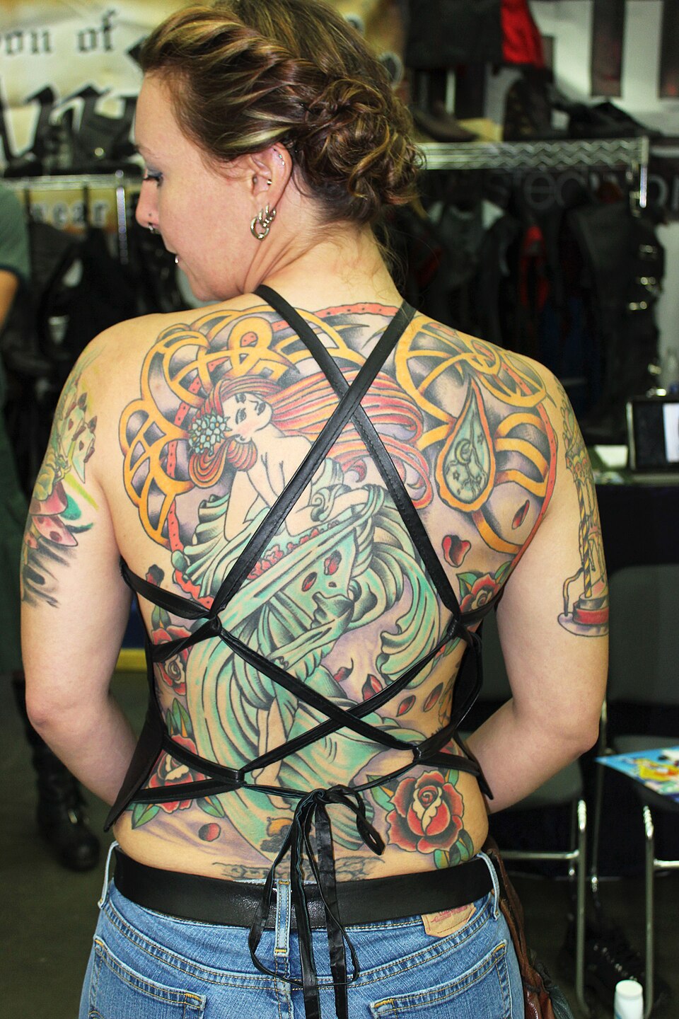 A Mucha-inspired back tattoo photographed in 2014. The source does not identify the tattoo artist.