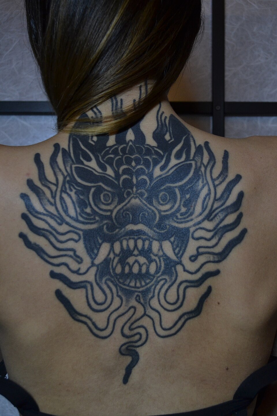 A dragon by Mattia Jey, tattooed in 2016 and photographed healed in 2017.