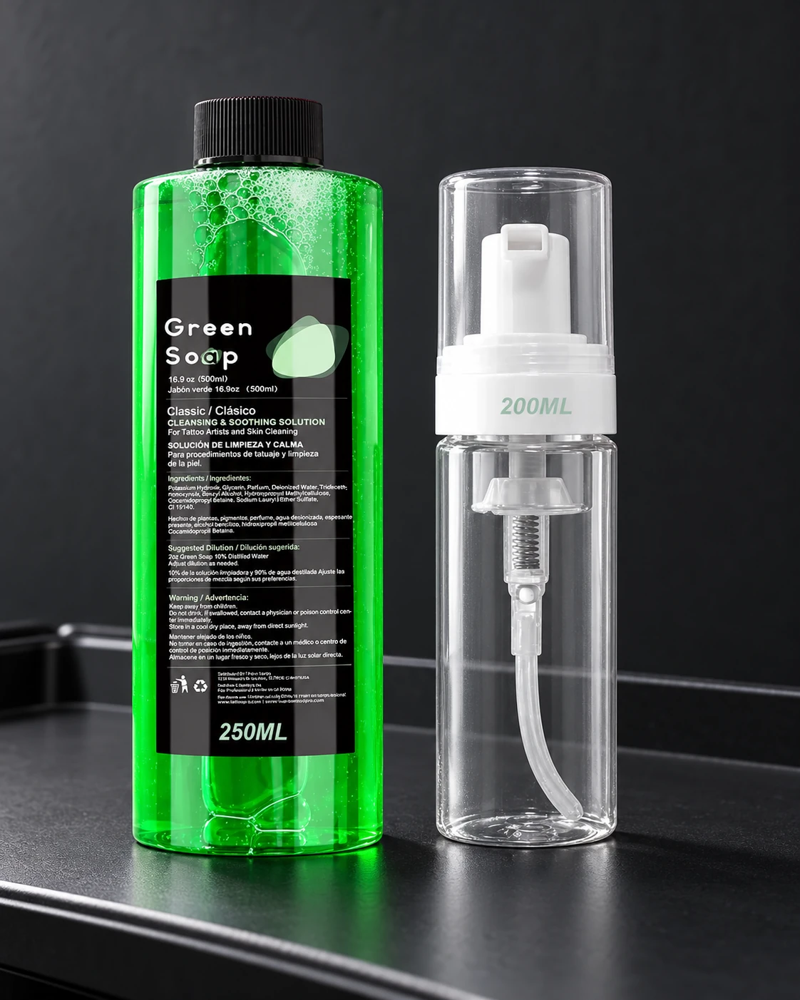 Green Soap bottle and clear foamer on a workstation tray